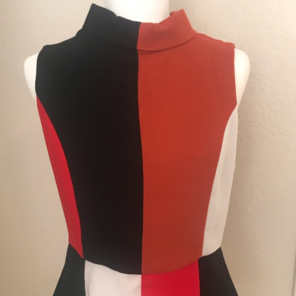 Color blocked mock turtleneck top with peplum